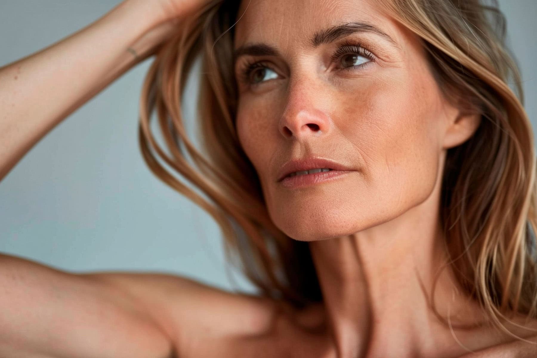 close up portrait of a woman with blonde hair looking up