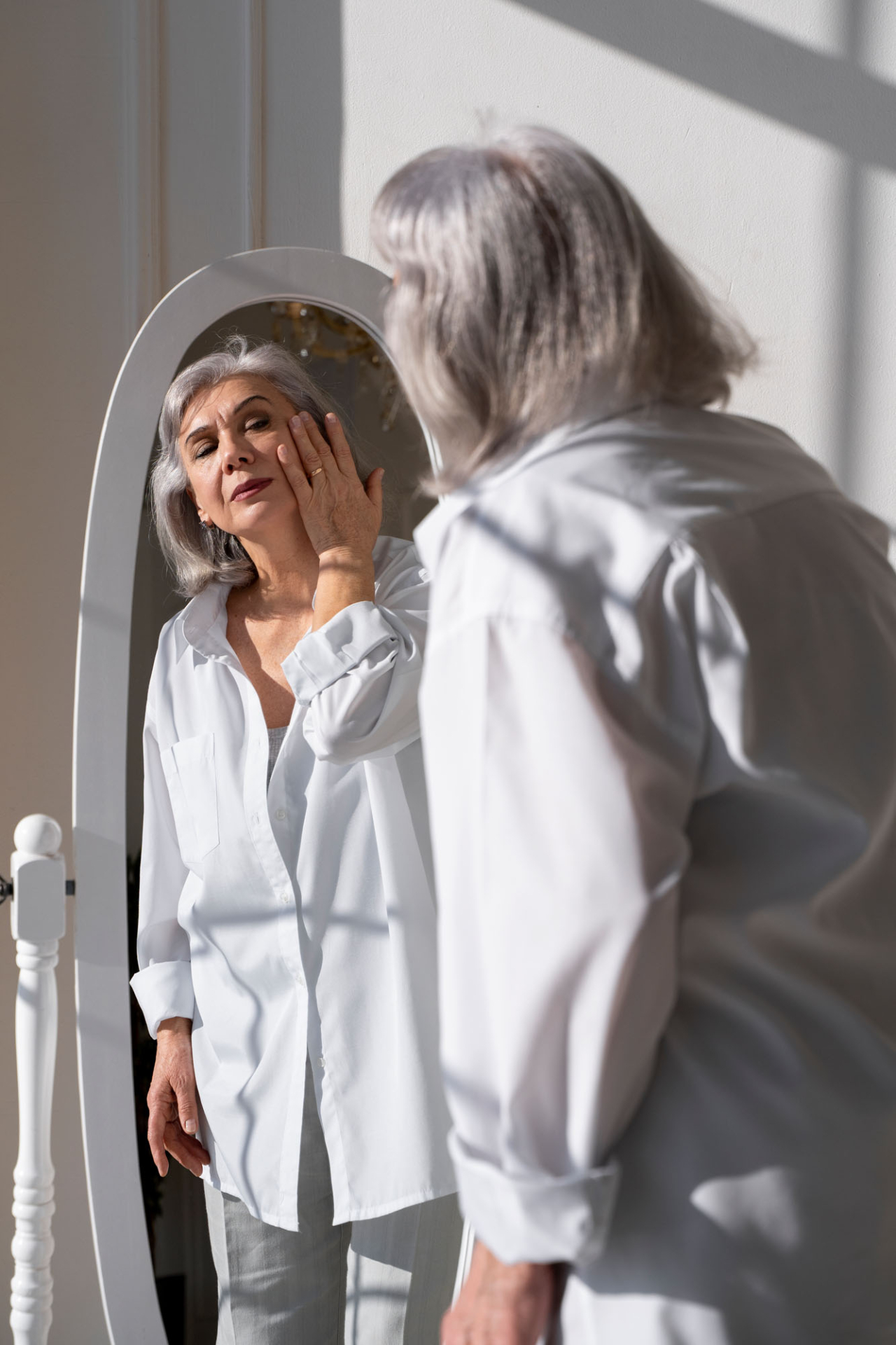 medium shot senior woman looking mirror