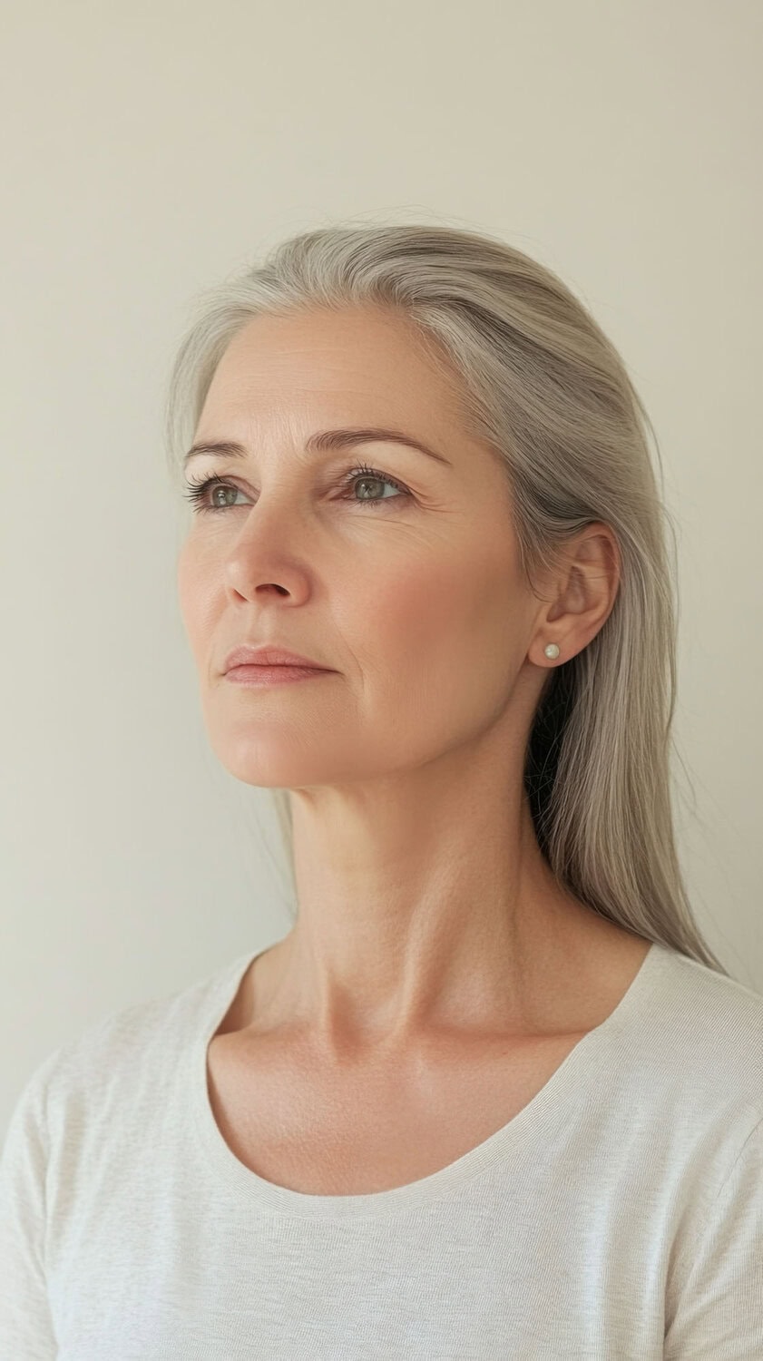 portrait serene mature woman with gray hair light background (1)