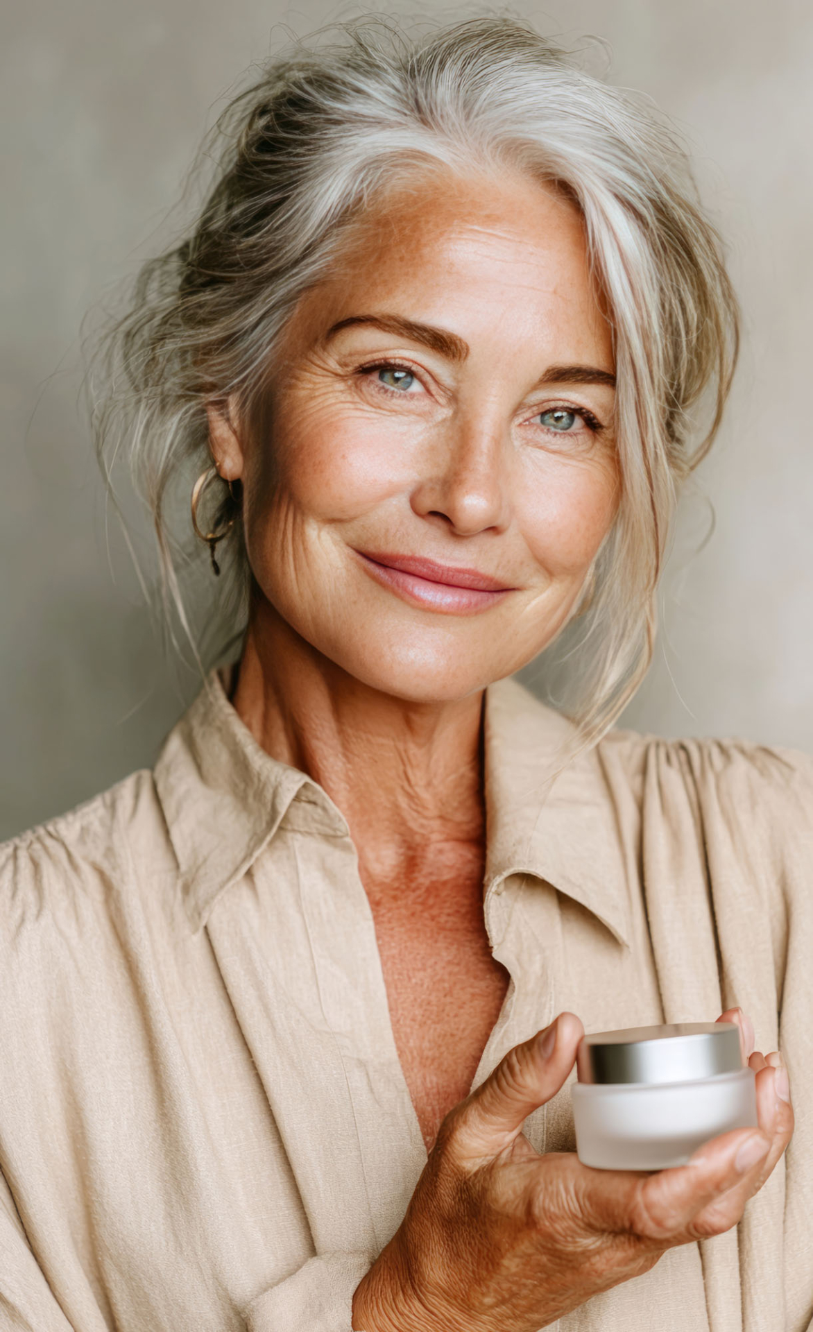 smiling senior woman holding moisturizer cream for skincare rout