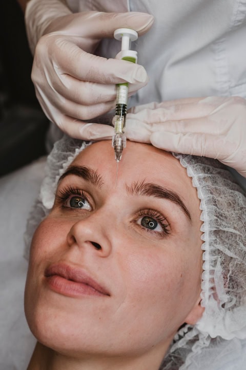 woman getting facial beauty injection wellness center