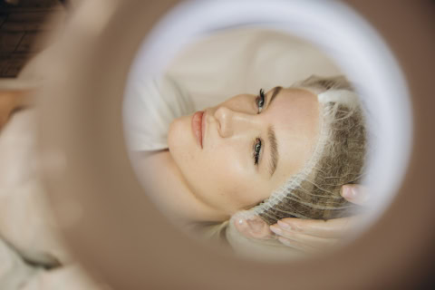 woman undergoing procedure of vacuum hydro peeling in beauty salon